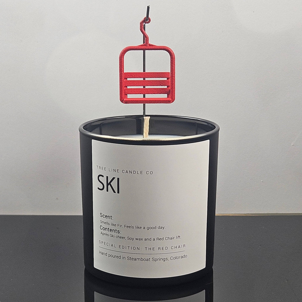Tree Line Candle Co. ski candle featuring a miniature red chairlift above a black glass vessel, hand-poured in Steamboat Springs, Colorado.
