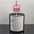 Tree Line Candle Co. ski candle featuring a miniature red chairlift above a black glass vessel, hand-poured in Steamboat Springs, Colorado.