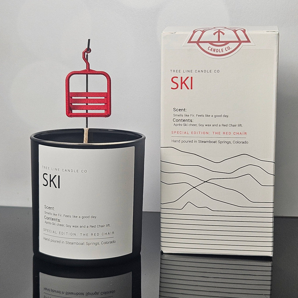Tree Line Candle Co. special-edition ski candle featuring a miniature red chairlift in a black glass vessel with coordinating gift box, hand-poured in Steamboat Springs, Colorado.
